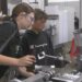 Senior Emily LaFave helps a middle school student during Wednesday's machining course