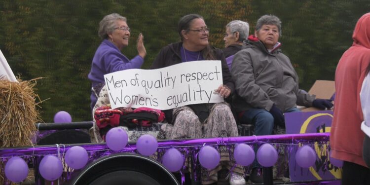 Donna Viers holds a sign on the Elders' float.