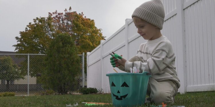 Shepard enjoys some non-food treats in his teal pumpkin bucket.
