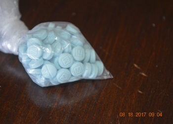 FILE - This undated file photo provided by the U.S. Drug Enforcement Administration's Phoenix Division shows a closeup of fentanyl-laced sky blue pills. Police in small city on the U.S.-Mexico border say three students have been arrested for possessing fentanyl pills on campus, including one who had over 3,000 pills with her. San Luis, Arizona, police say two 18-year-old girls and a 16-year-old boy were arrested Wednesday, June 5, 2019 after an on-campus officer found them with pills. (Drug Enforcement Administration via AP, File)