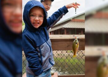 (Courtesy: Michigan Department of Natural Resources) A young boy holds up a bluegill he caught at the Michigan Department of Natural Resources Pocket Park in Escanaba