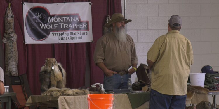 Antczak talks with an attendee at his booth.