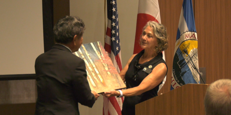 Marquette Mayor Sally Davis presents Mayor Ogura with artwork