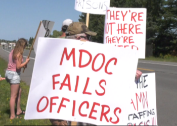 Dozens of corrections officers walk the picket line in Baraga