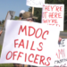 Dozens of corrections officers walk the picket line in Baraga
