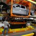 (Jeff Kowalsky/AFP/Getty Images via CNN Newsource) The truck cab is lowered on the frame of Ford Motor Co. battery powered F-150 Lightning trucks.