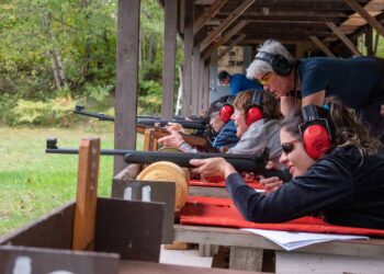 (Credit: Michigan Department of Natural Resources) Women practice shooting at a Becoming an Outdoors-Woman fall weekend workshop in Marquette County. Registration is open for an Oct. 11-13 event at the Bay Cliff Health Camp north of Marquette.