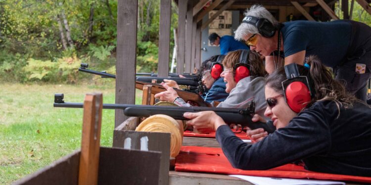 (Credit: Michigan Department of Natural Resources) Women practice shooting at a Becoming an Outdoors-Woman fall weekend workshop in Marquette County. Registration is open for an Oct. 11-13 event at the Bay Cliff Health Camp north of Marquette.