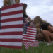 Under a US flag at half mast, students at Marquette Senior High School honored the victims of the 9-11 attacks by planting American flags in front of their school this morning.