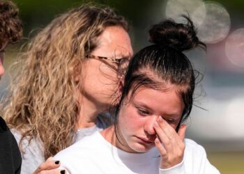 (Mike Stewart/AP via CNN Newsource) A student weeps at a makeshift memorial after a shooting Wednesday at Apalachee High School, on September 5, in Winder, Georgia.