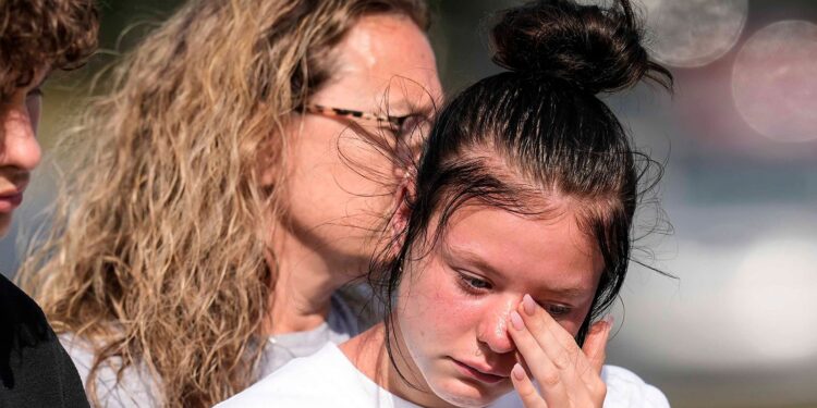 (Mike Stewart/AP via CNN Newsource) A student weeps at a makeshift memorial after a shooting Wednesday at Apalachee High School, on September 5, in Winder, Georgia.