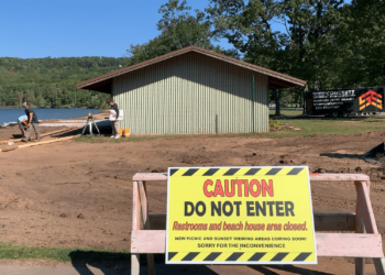 A sign cautions park visitors from entering the construction area as the Lake Antoine Park Partners work to make the beach area more handicap accessible.