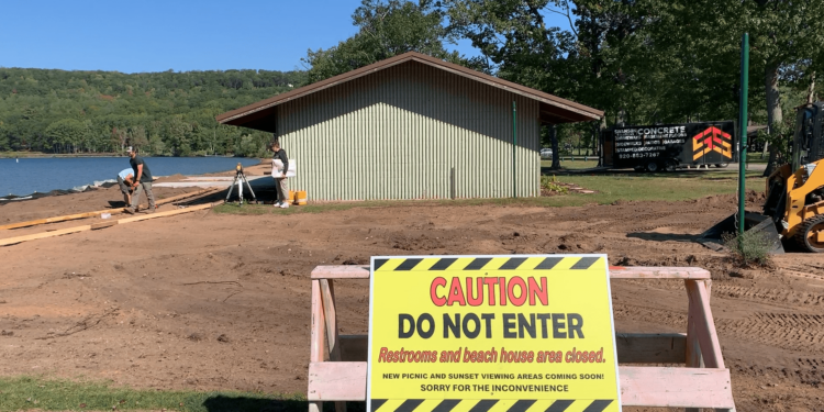 A sign cautions park visitors from entering the construction area as the Lake Antoine Park Partners work to make the beach area more handicap accessible.