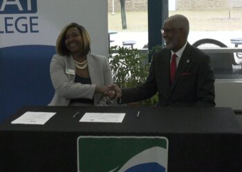 Dr. Hughes and Dr. Grant shake hands at Monday's event