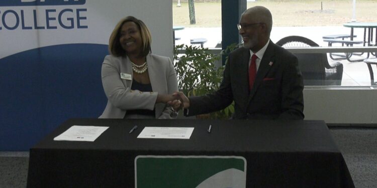 Dr. Hughes and Dr. Grant shake hands at Monday's event