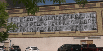 These 72 Large-scale black-and-white portraits line the rear facade of the Delft Theatre — everyday people who’ve worked, lived, and given back to the community, but whose contributions often go unrecognized.