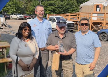 Visit Keweenaw presents Markkanen with award at Mount Bohemia. Photo courtesy of Visit Keweenaw