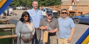 Visit Keweenaw presents Markkanen with award at Mount Bohemia. Photo courtesy of Visit Keweenaw