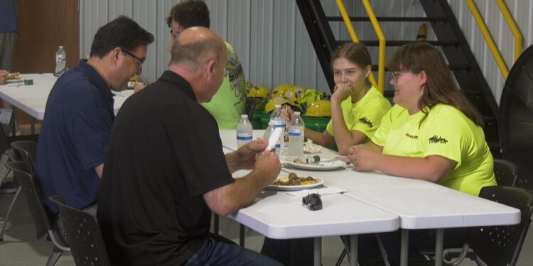 Two of the camp's five female students network with local professionals