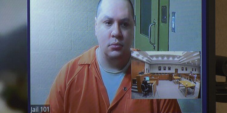 Jackson appears in court from the Delta County Jail via Zoom.