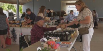 Rod Lanaville of Lanaville Garlic Farm makes a sale a the first market of the year.