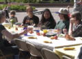 A simple meal can go a long way toward bringing people together. That's the idea behind Marquette's longest table community picnic, part of this year's Spread Goodness Day celebration.