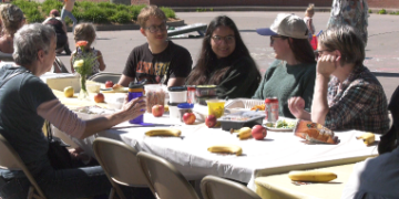 A simple meal can go a long way toward bringing people together. That's the idea behind Marquette's longest table community picnic, part of this year's Spread Goodness Day celebration.