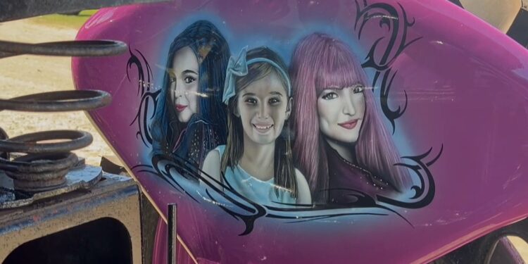 The tractor features artwork of Kaydence with characters from her favorite Disney Channel movie series