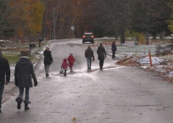 Marquette Trick-or-Treaters cross a street, 2024